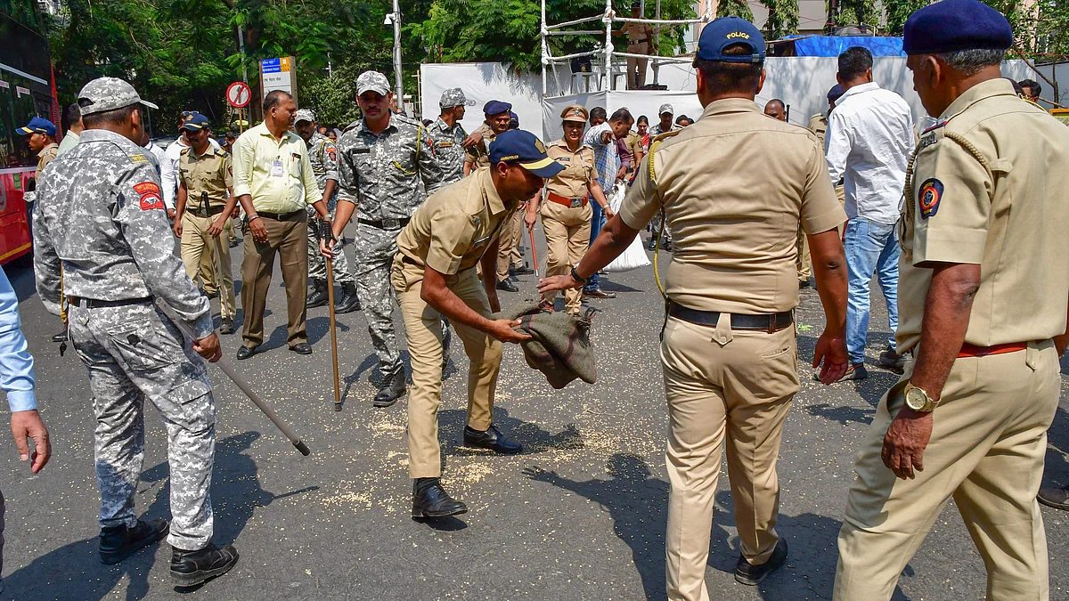 Police remove grain outside Vidhan Bhavan in Mumbai on 11 March (photo: PTI)