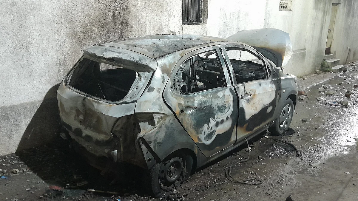 A charred vehicle in Nagpur 17 March (photo: PTI)
