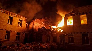 fire and smoke engulf a building after a Russian attack in Krasnopillia, Sumy region, Ukraine
