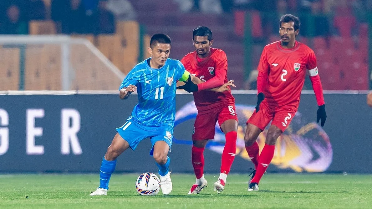 Look who's back: Sunil Chhetri screens the ball against two Maldives defenders (photo: AIFF)