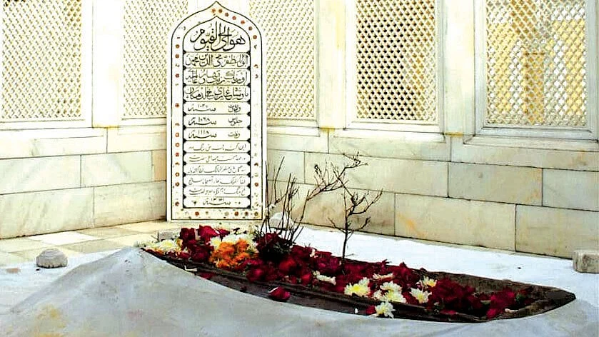 Aurangzeb’s grave is a simple stone slab with soil on top, where a plant grows