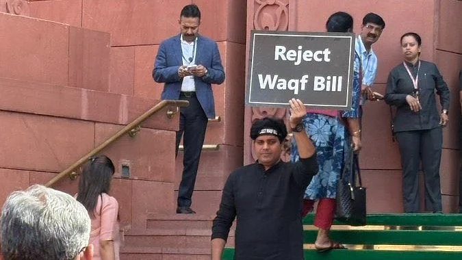 MP Imran Pratapgarhi holds up a placard outside Parliament (photo: @ShayarImran/X)
