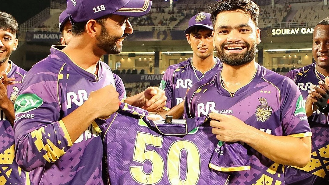 Rinku Singh is handed a celebratory '50' shirt by KKR skipper Ajinkya Rahane 