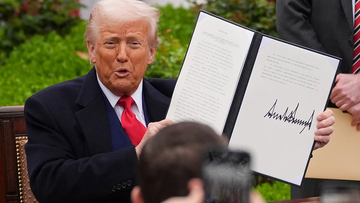 Donald Trump holds a signed executive order in Washington on 2 April (photo: AP/PTI)