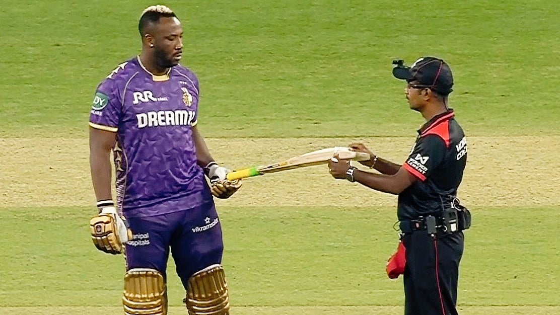 Andre Russell of KKR gets his bat 'gauged' (photo: @Vipul_Espeaks/X) 
