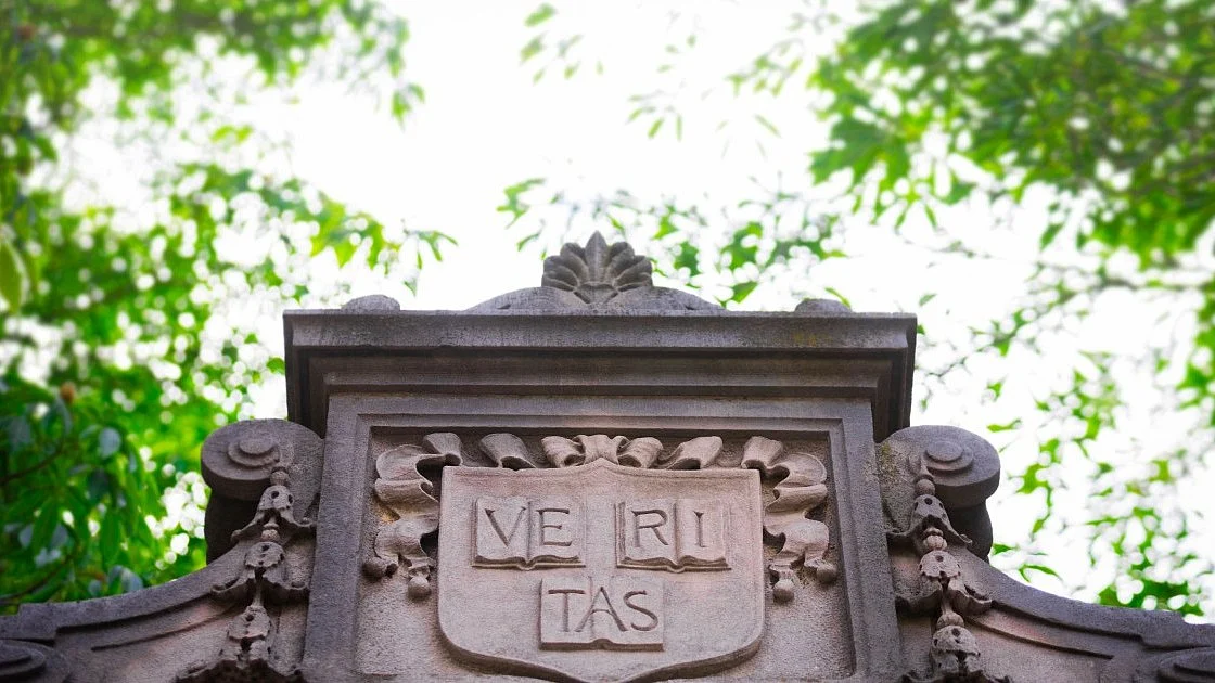 Harvard’s shield carved in stone displays the Latin word 'Veritas', meaning 'truth'