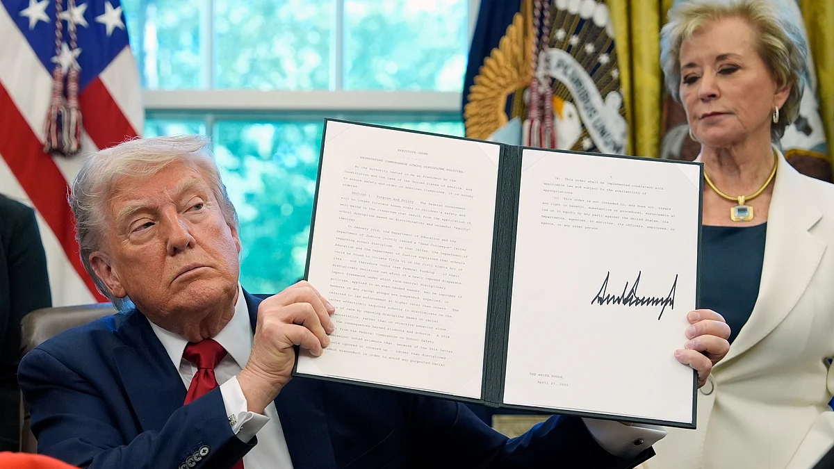 Donald Trump holds a signed an executive order at White House on 23 April (photo: AP/PTI)