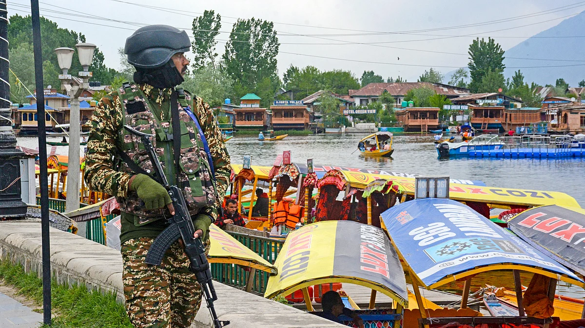 A security official keeps vigil on the banks of the Dal Lake in Srinagar (photo: PTI)