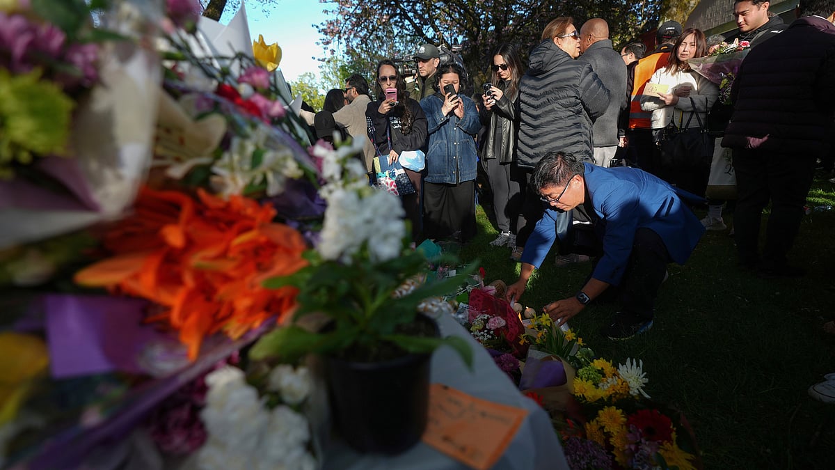 People leave flowers and light candles at a memorial in Vancouver 27 April (photo: AP/PTI) 
