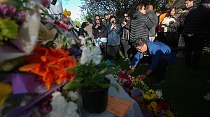 People leave flowers and light candles at a memorial in Vancouver 27 April (photo: AP/PTI)