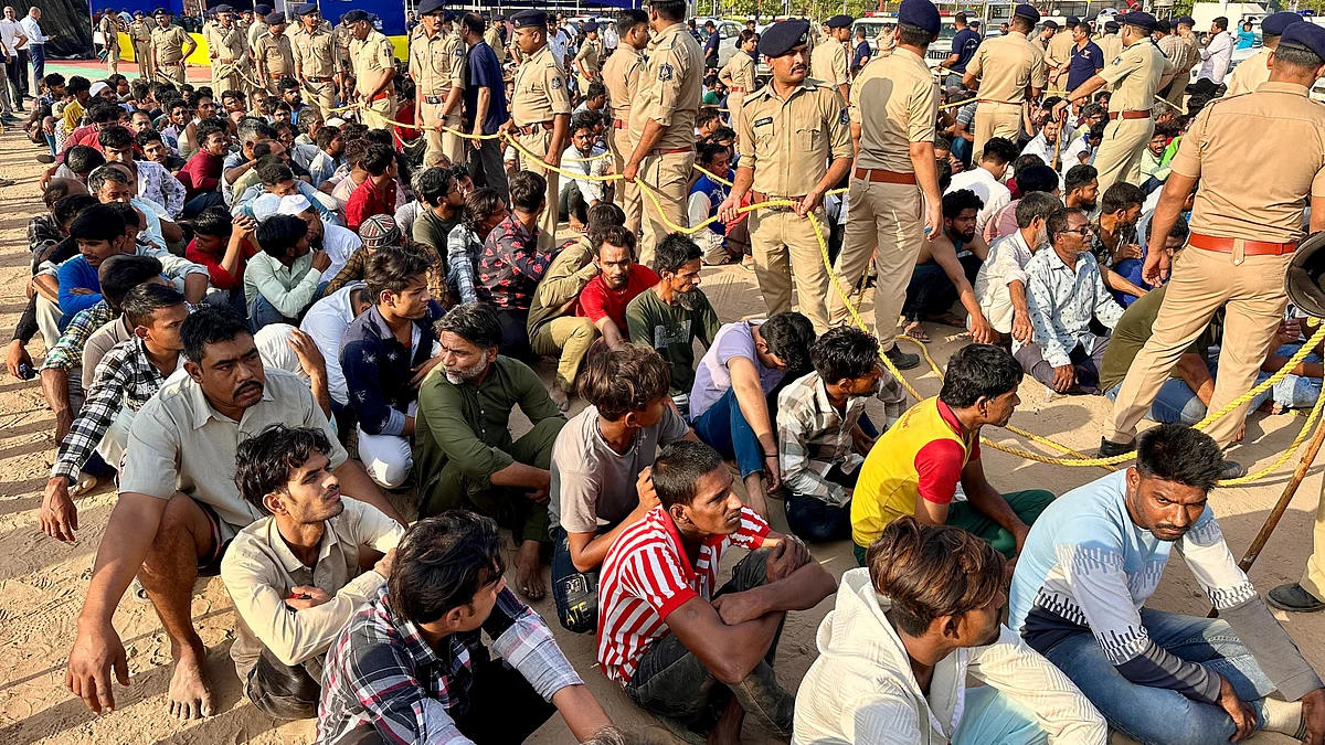 Illegal immigrants in police custody in Ahmedabad on 26 April (photo: PTI)