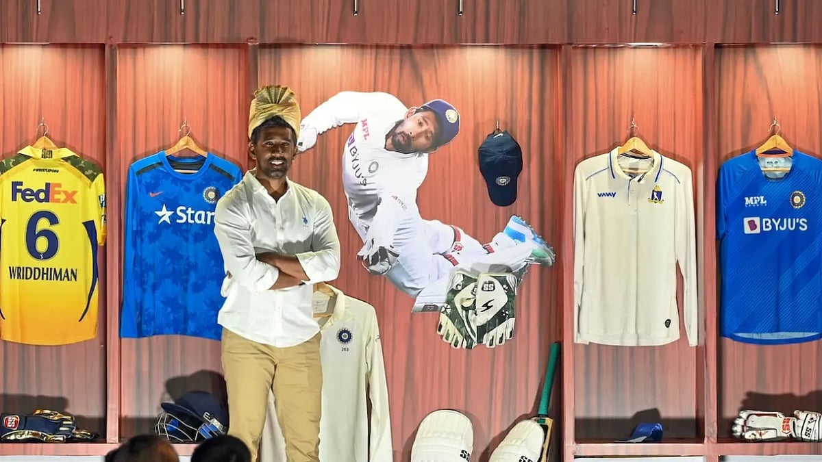 Wriddhiman Saha poses in front his jerseys at CAB felicitation