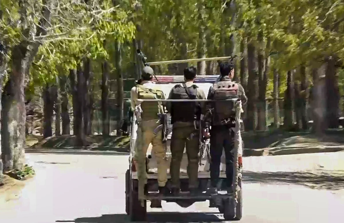 NIA personnel on their way to Baisaran from Pahalgam police station (photo: PTI)