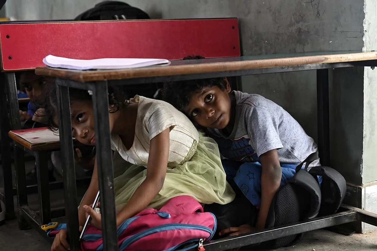 Children in the NCR crouch under their desks at school as part of a civilian mock drill (Vipin/NH)
