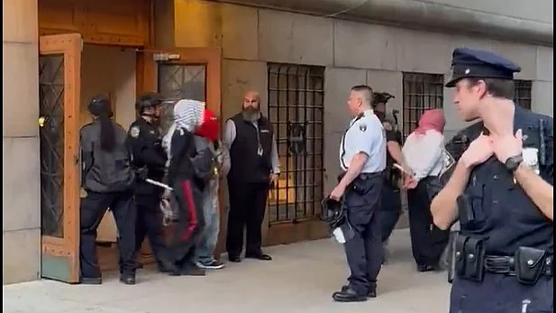 More than 30 people were taken away by officers with their hands tied behind their backs