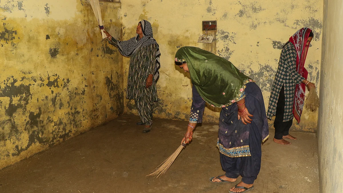 Women clean a bunker at a village in Jammu on 6 May (photo: PTI)