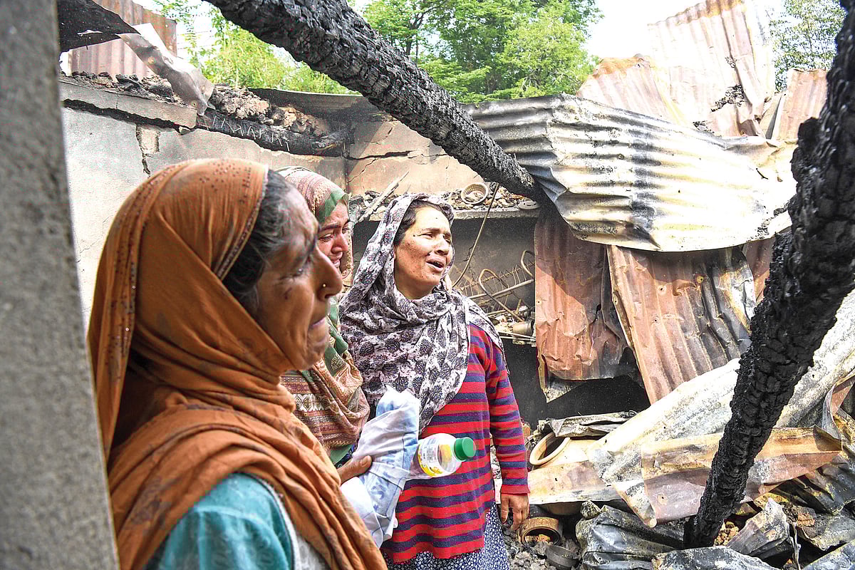 Women mourn the loss of their home in Uri