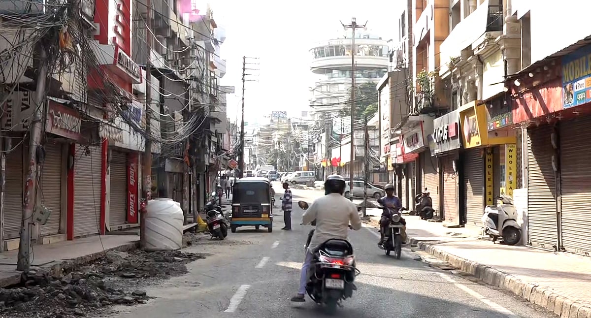 Shops still shut in Raghunath Bazaar, Jammu, though a few people are out and about