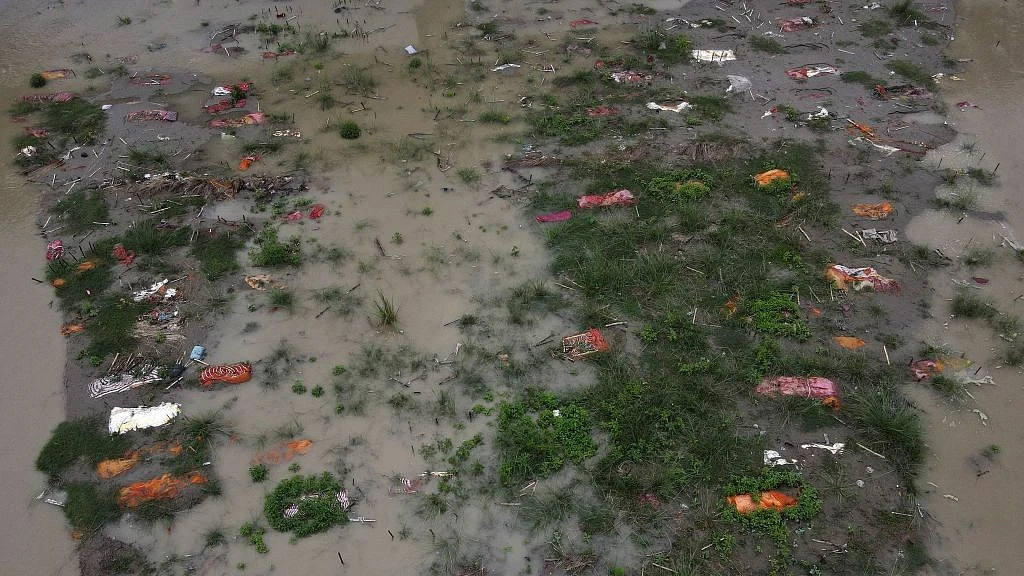 Ganges River waters expose wrapped bodies of suspected coronavirus deaths at Phaphamau ghat, June 2021
