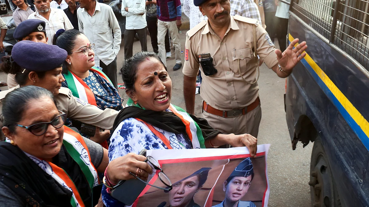 Police detain Congress workers during their protest in Ahmedabad on 15 May (photo: PTI)