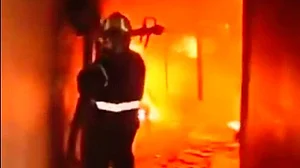 Video screengrab of a firefighter battling the raging flames.