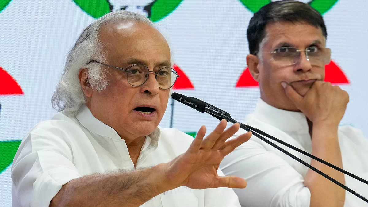 Jairam Ramesh with Pawan Khera addresses a press conference in New Delhi on 14 May (photo: PTI)
