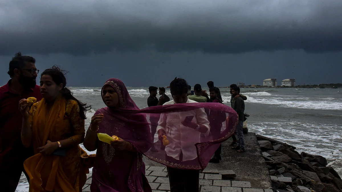 Visitors retreat from a Kochi beachfront as the sky lowers