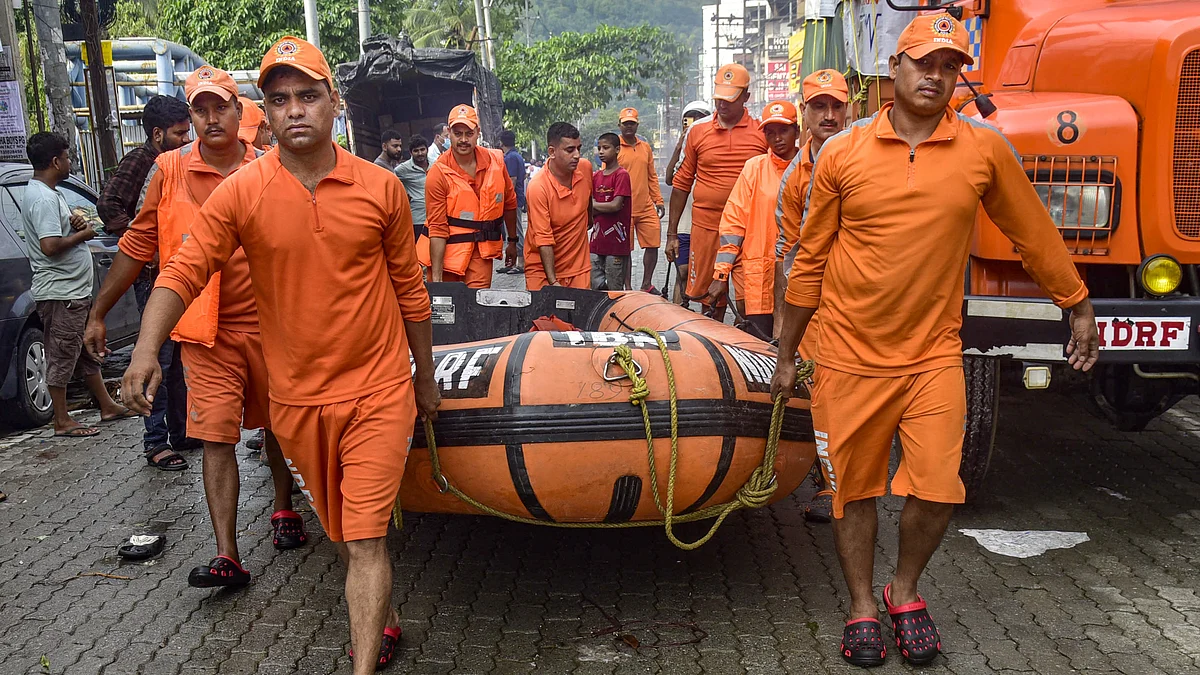 NDRF personnel carry a rescue boat in Guwahati (photo: PTI)