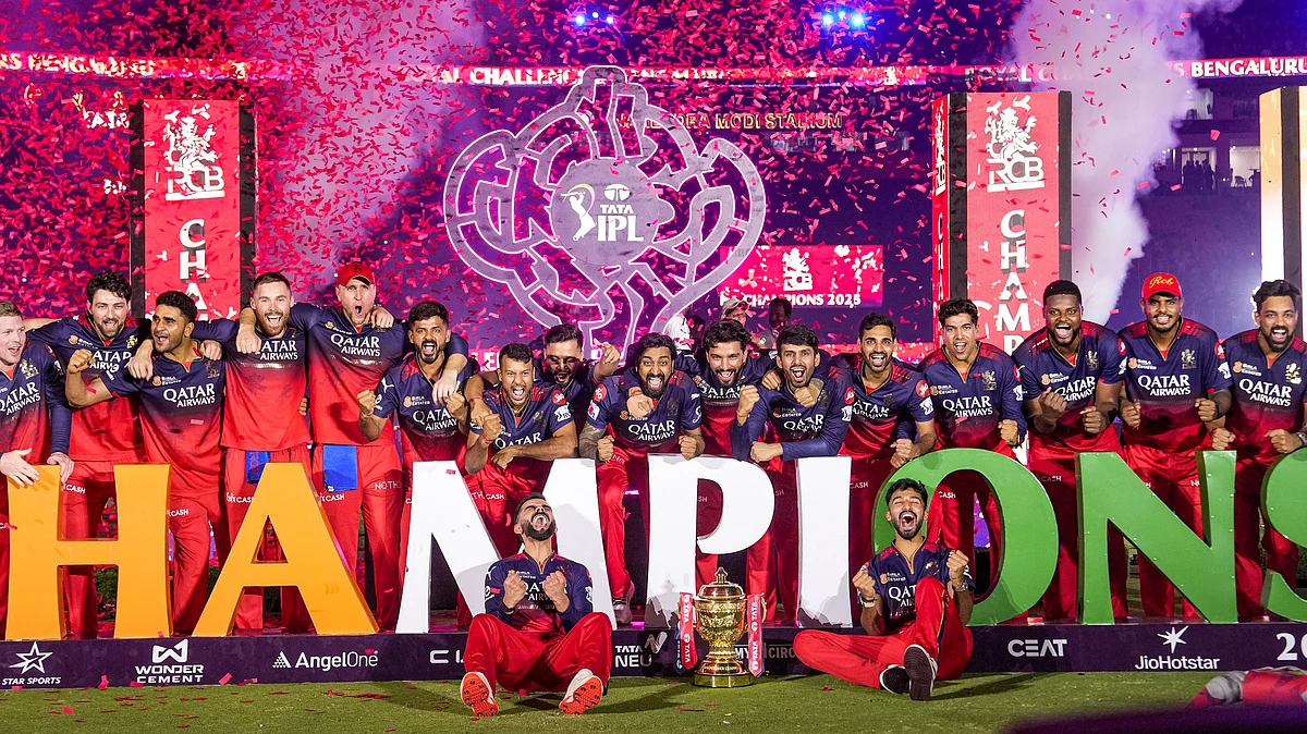 Team RCB celebrate with championship trophy in Ahmedabad on 3 June (photo: PTI)