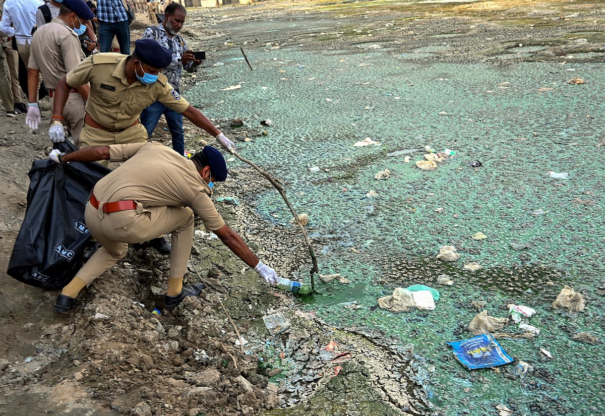 Policing plastic pollution: Khaki-clad squads pull trash from the Sabarmati river in Ahmedabad, Gujarat