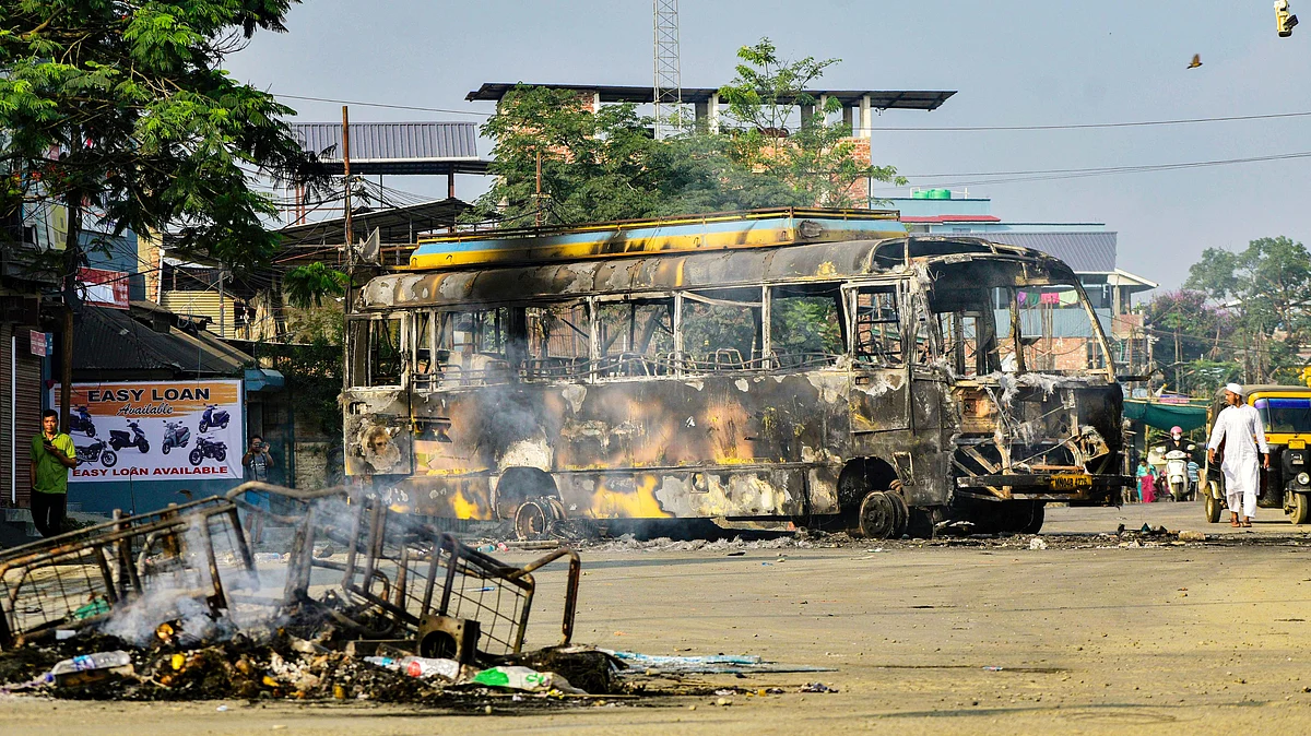 A bus set on fire after protests erupted over the arrest of an Arambai Tenggol leader (photo: PTI)