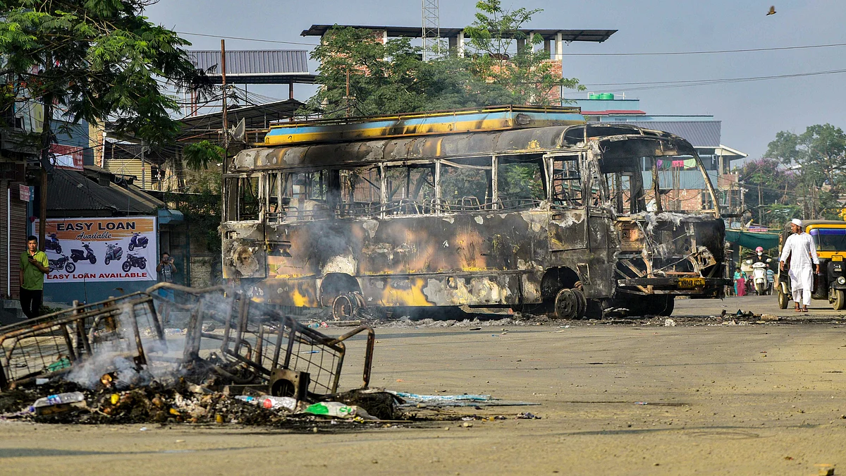 Charred remains of a bus in Imphal on 8 June (photo: PTI)