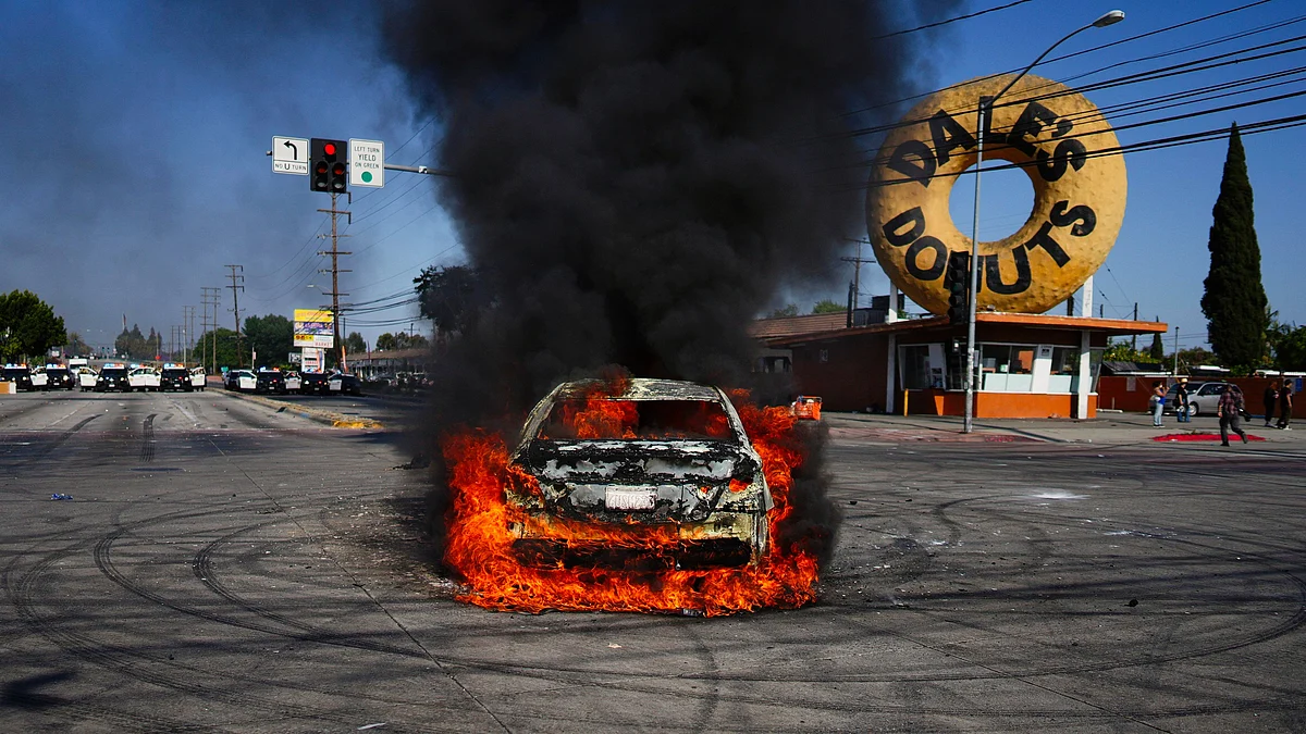 A car burns during a protest in Compton, California on 7 June (photo: AP/PTI)