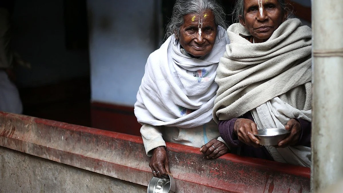 Two of the 20,000 widows of Vrindavan, with their little begging bowls to survive upon
