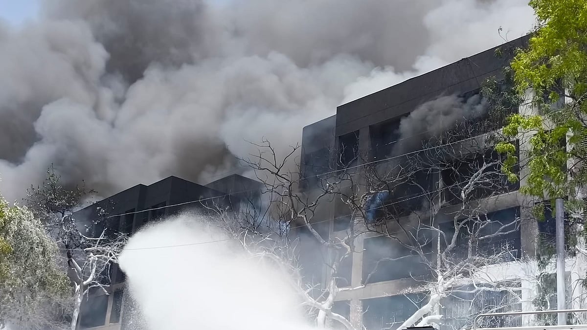 Thick black smoke wraps the BJ Medical College building after the plane crash