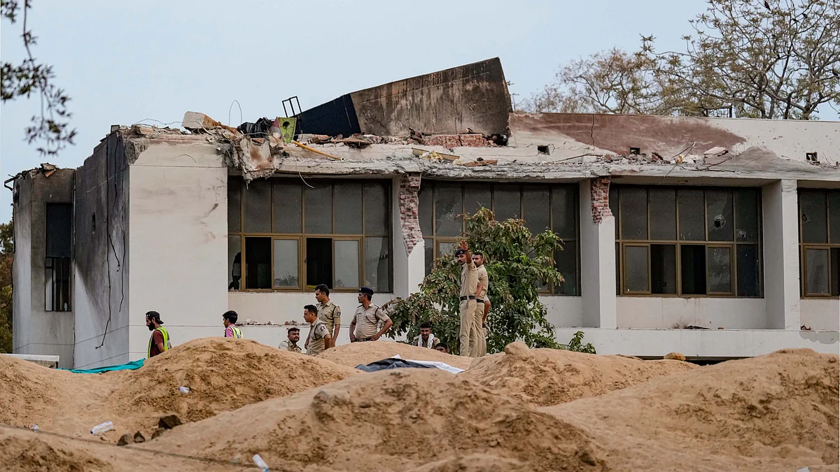 Police personnel at the site of the Air India plane crash, in Ahmedabad. (photo: PTI)
