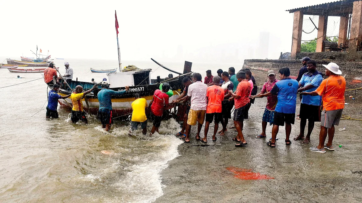 Fishermen pull their boats ashore before the monsoons hit Mumbai (photo: Getty Images)