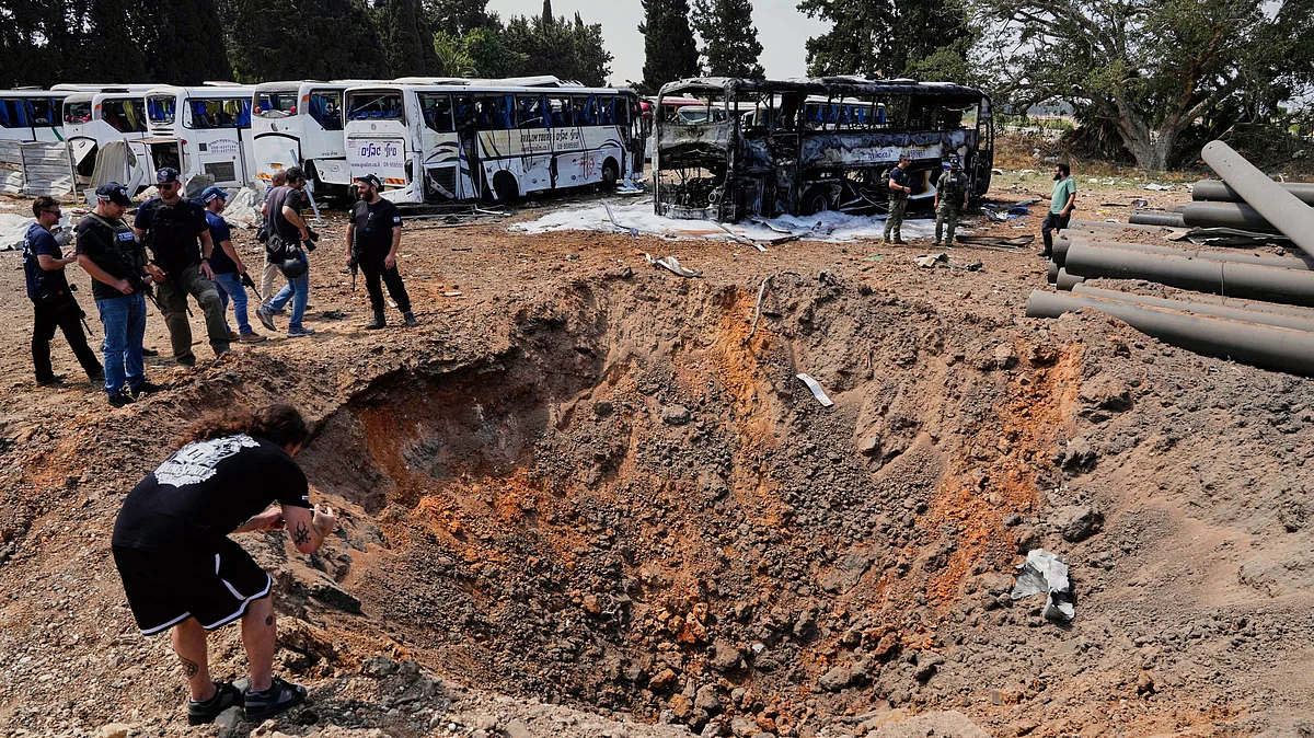 Israeli security forces inspect a site hit by an Iranian missile, on 17 June (photo: AP/PTI)
