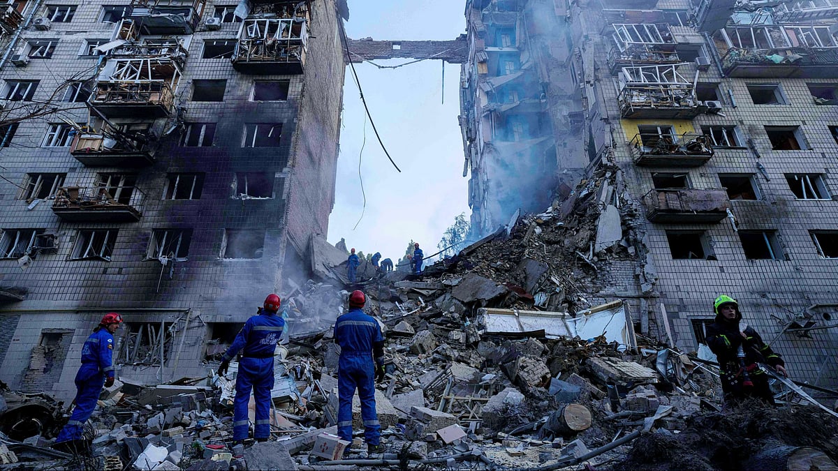 Rescue workers clear rubble of a multi-storey residential house in Kyiv on 17 June (photo: AP/PTI)