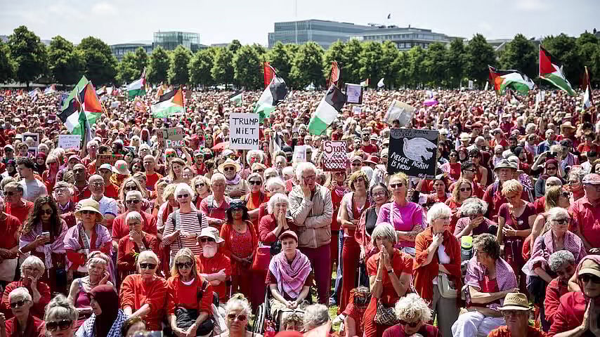 Amongst the pro-Palestine 'Red Line' protestors at The Hague, one holds a 'Trump Niet Welkom' placard