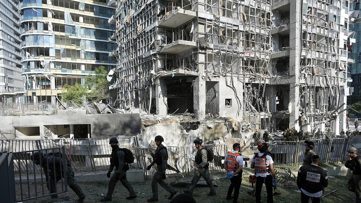 Rescue workers inspect the site in Ramat Gan, Israel on 19 June (photo: AP/PTI)