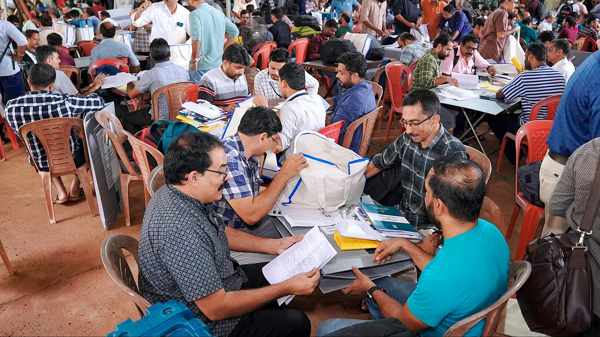 Polling officials at Malappuram district on 18 June (photo: PTI)
