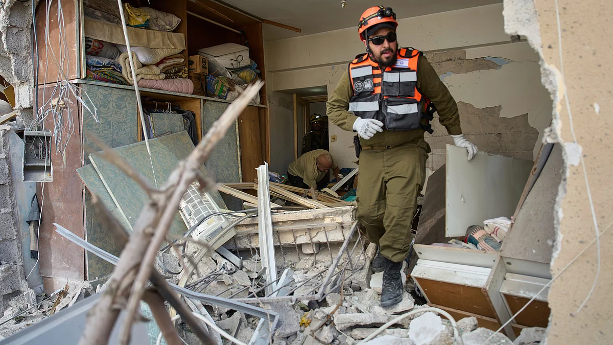 A rescue official at a destroyed building in Israel on 19 June (photo: AP/PTI)