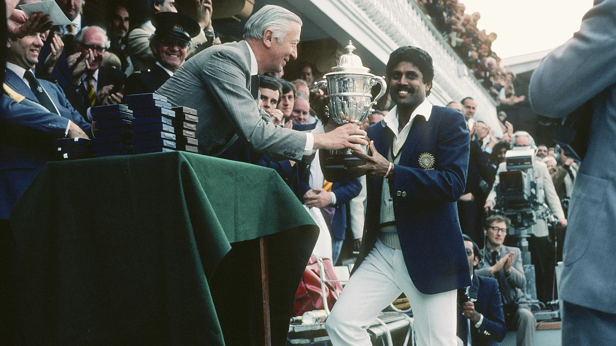 Skipper Kapil Dev receives the trophy (courtesy: @BCCI/X)