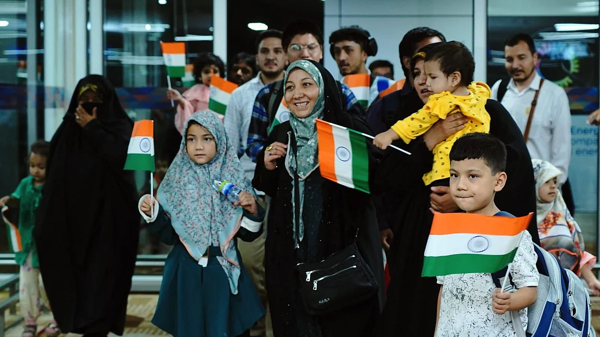 Indian nationals arrive at Delhi airport on 26 June (photo: PTI)