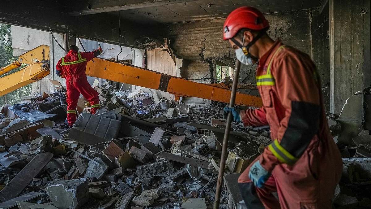 Rescuers conduct search operation in Tehran on 24 June (photo: AP/PTI)