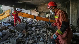 Rescuers conduct search operation in Tehran on 24 June (photo: AP/PTI)