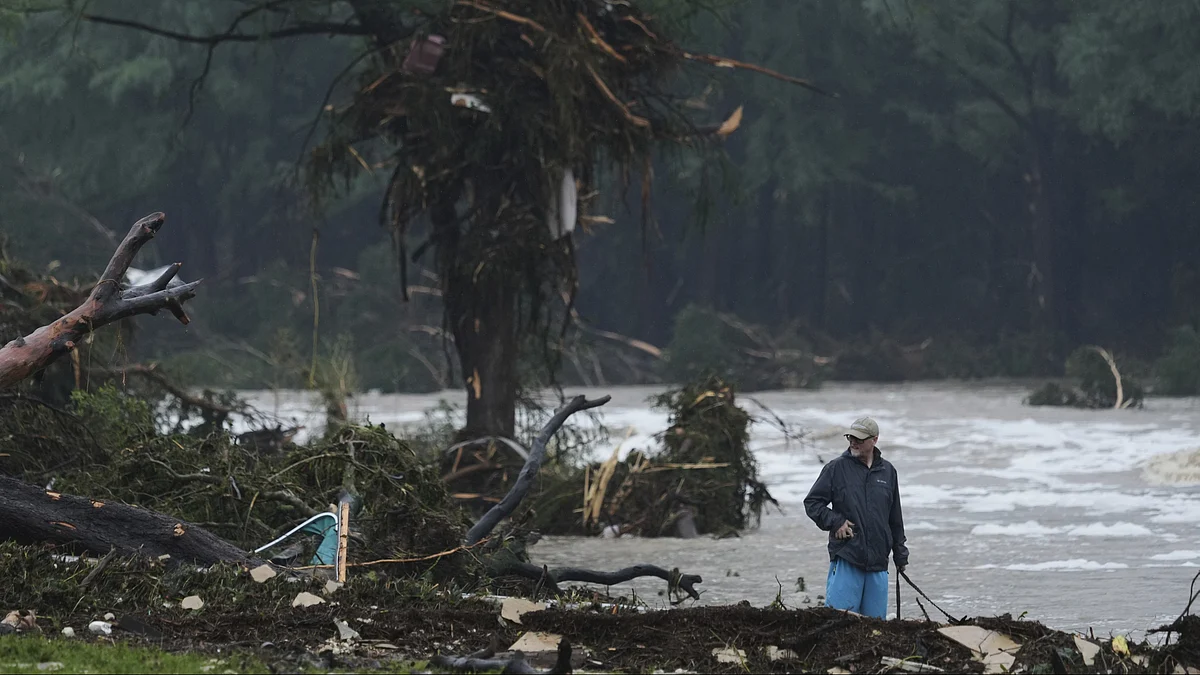 A man surveys debris along the Guadalupe River in Texas on 4 July  (photo: AP/PTI)