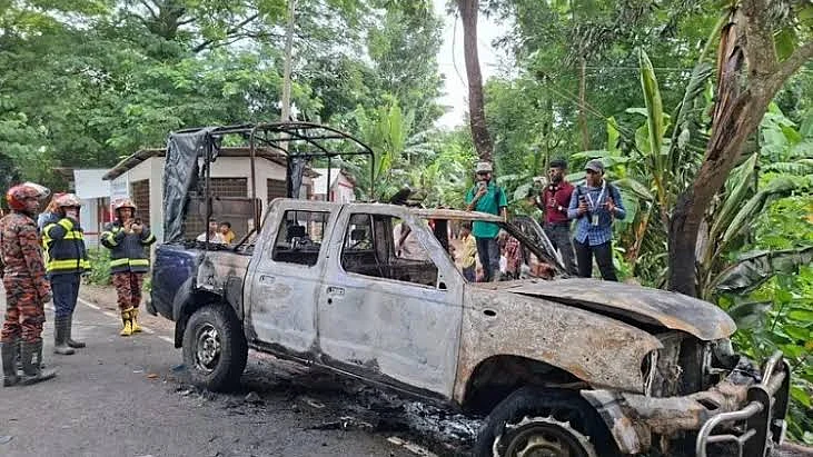 A police vehicle torched by a mob in Gopalganj