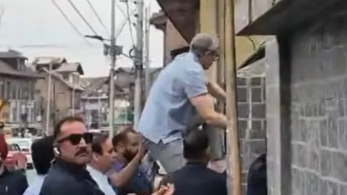 J&K chief minister Omar Abdullah scales a wall to enter the Mazar-e-Shuhada in Srinagar, 14 July 2025